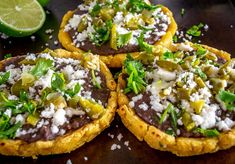 some food is sitting on a table with limes and other things around it,