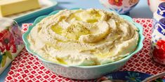 a bowl filled with mashed potatoes on top of a table