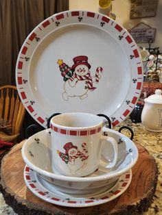 a stack of christmas themed dishes sitting on top of a table