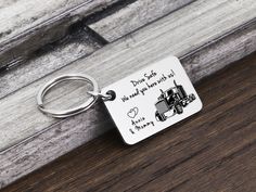 a metal keychain with a drawing of a tractor on it that says, don't start we need you with up