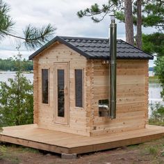 a small wooden cabin sitting next to a body of water