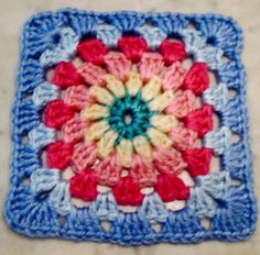 a crocheted square with red, white and blue colors