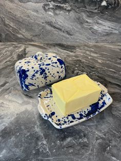 a piece of butter sitting on top of a blue and white plate