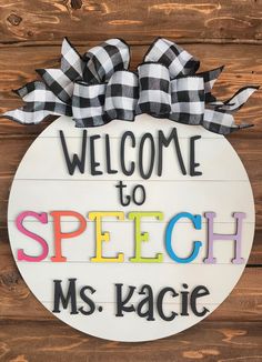 a sign that says, welcome to speech ms kacice on the side of a wooden wall