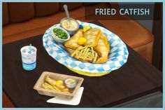 there is a plate of fried fish and fries on the table