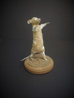 a figurine of a dog dressed in sand