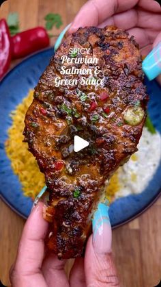 someone is holding up a piece of food on a blue plate with rice and peppers