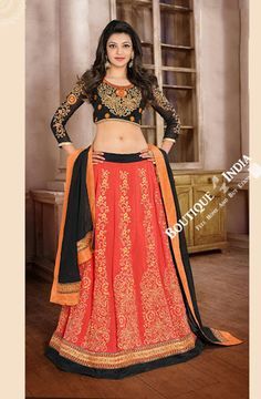 a woman in an orange and black lehenga