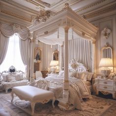 a fancy bedroom with four poster bed and white furniture