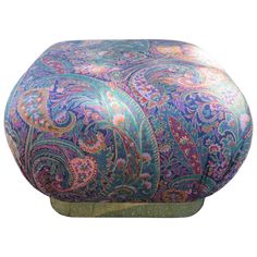 an ottoman covered in colorful paisley fabric