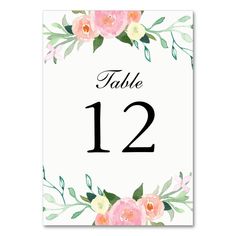 a table number card with watercolor flowers on it