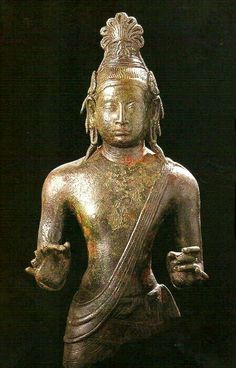 an old bronze statue is shown on display