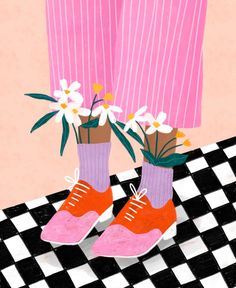 a pair of pink shoes with flowers in them on a checkered black and white floor