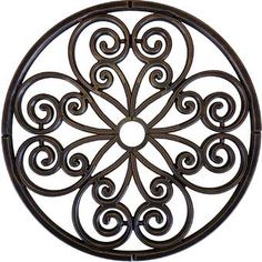 a metal circular wall decoration with swirl designs