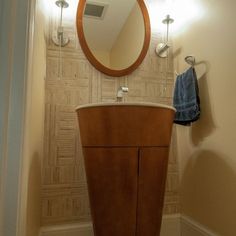 a bathroom with a sink, mirror and towel rack