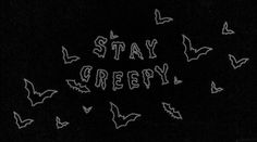 the words stay creepy written in white chalk on a black background with bats flying around