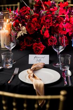 a place setting with flowers and candles on the table for an elegant dinner or reception