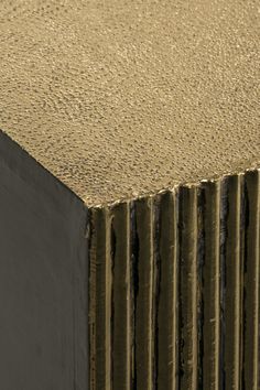 a close up view of the top of a wooden table with metal slats on it