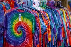 tie - dyed shirts are on display in a store