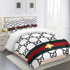 a bed in a room with white walls and black and red stripes on the comforter