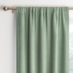 a green curtain hanging on the side of a window