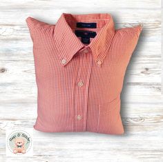 an orange and white checkered shirt on a pillow