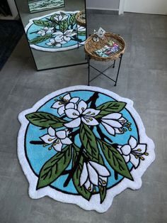 two mirrors with flowers on them in a room next to each other and a chair