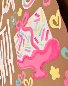 a large piece of art painted on the side of a wall with donuts and sprinkles