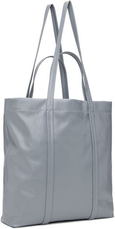 Grained leather tote in gray. · Twin carry handles and shoulder straps · Logo tag at shoulder strap · Logo hardware at face · Open throat · Zip pocket at interior · Plain-woven lining · H13.5 x W15.5 x D3 Supplier color: Grey blue Classic Gray Top Handle Bag, Classic Gray Leather Bag, Everyday Gray Satchel With Double Handle, Classic Shoulder Bag With Rolled Handles For Errands, Everyday Gray Double Handle Satchel, Luxury Soft Leather Gray Bag, Gray Leather Shoulder Bag With Top Carry Handle, Gray Leather Shopping Bag, Gray Shoulder Bag With Double Handle For Errands