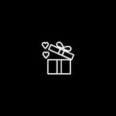 a black and white image of a gift box with a heart shaped bow on it