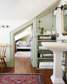 an image of a bedroom with green walls and wood flooring on the bottom level