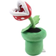 a stuffed toy with a red and white mushroom on it's head in a green cup