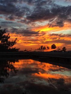 the sun is setting over a body of water