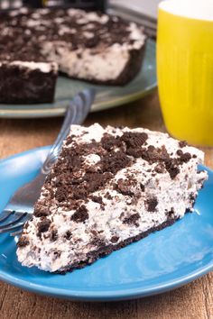 a piece of oreo cake on a blue plate with a fork next to it