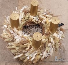 a wreath with candles and feathers on it