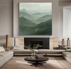 a living room filled with furniture and a large painting on the wall above it's fireplace