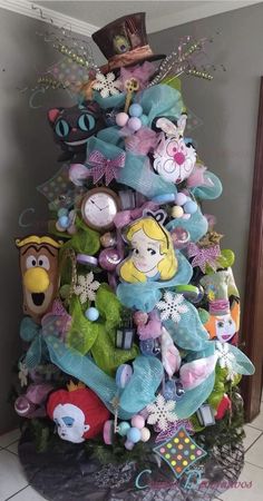 a christmas tree decorated with toys and other items in the shape of disney's characters