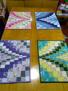 three quilts are sitting on the table together