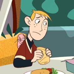 a cartoon character sitting at a table with food in front of him and an empty container behind him