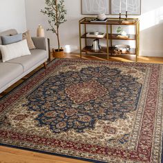 a living room filled with furniture and a large rug on top of a hard wood floor