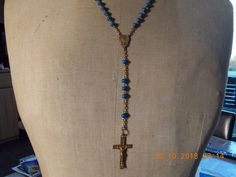 "Vintage French  Rosary Beads Necklace in Blue crucifix Cross religious chain Jesus cross jewellery Vintage French  Vintage French Rosary Beads Necklace crucifix Cross religious chain Jesus cross. Nice necklace Gold in colour with Blue beads, length of chain that goes around your neck is 21\" (53cm) but does have an extra drop of 5\" (13cm) where the cross hangs down. Nice piece of religious jewellery. Christian cross. Please have a look at my other Rosary bead chains for sale." Blue Crucifix Necklace For Spiritual Wear, Blue Crucifix Necklace For Spiritual Purposes, Adjustable Blue Cross Necklace, Blue Adjustable Cross Necklace, Handmade Blue Crucifix Jewelry, Spiritual Blue Cross Pendant Necklace, Blue Cross Spiritual Necklace, Handmade Blue Rosary With Cross Shape, Blue Rosary With 8mm Beads In Cross Shape