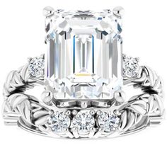 an emerald - cut diamond ring set with diamonds on the band