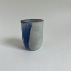 a blue and white cup sitting on top of a table