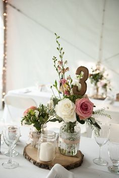 the table is set with flowers and candles