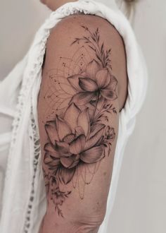 a woman's arm with flowers on it