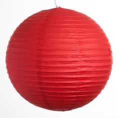 a red paper ball hanging from a string