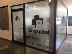 a glass display case with the words dogspital written in black and white on it