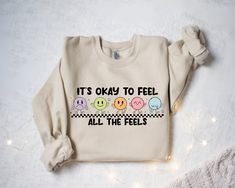 a sweater that says it's okay to feel all the feelss on it