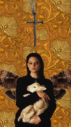 a woman holding a lamb in front of a cross and wallpaper with gold flowers