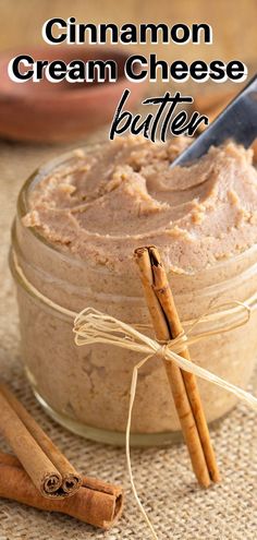 cinnamon cream cheese butter in a small glass jar with two cinnamon sticks on the side